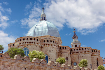 The stunning architecture of the Basilica of the Holy House in Loreto under a vibrant blue sky....