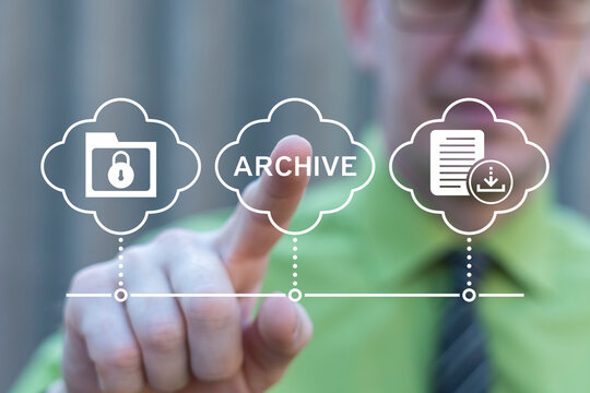 Business person working on virtual touch screen presses word: ARCHIVE. Archive concept. Online archival technology. E-document management software system. Filing cabinet, web storage of documents.