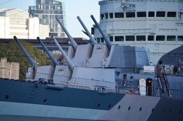 London, England, United Kingdom - October 2024:HMS Belfast moored in front of Tower Bridge on the...