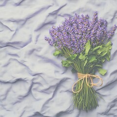 Naklejka premium A bouquet of lavender on a textured fabric background.
