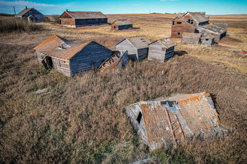 A rural area with a lot of old buildings and a lot of grass