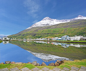 Seydisfjordur - Icelandic Village and mountain with reflection in the fjord.