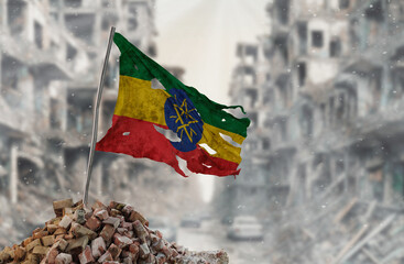 Dirty and torn Ethiopia flag, symbol of resistance and victory. A scene of war and devastation, the ruins of a city destroyed by conflicts. 3D Rendering.