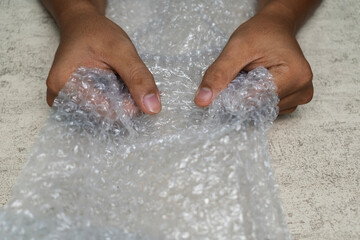 Fototapeta premium male hands popping bubble wrap to releasing stress