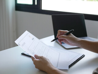 Fototapeta premium Businesswoman employer holding resume of job applicant to analyze data before job interview, recruit new employee, about recruitment