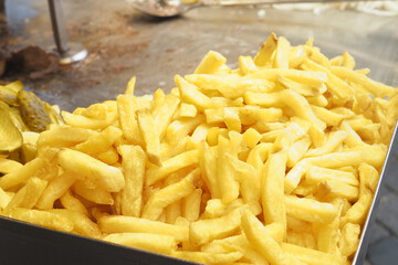 A Pile of Golden Crispy French Fries Located in a Bustling Fast Food Setting Enjoying Popularity