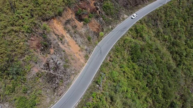 Aerial top-down view of vehicle driving along curvy mountain road between Guaranda and Montalvo, Ecuador