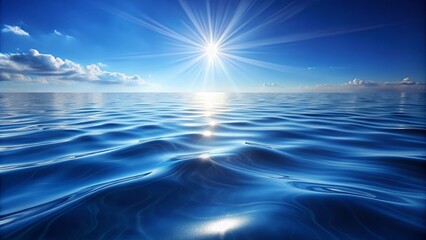 Obraz premium Serene Ocean Surface Reflecting the Sun's Rays with Gentle Waves and a Clear Blue Sky