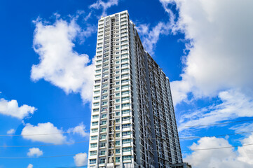 Fototapeta premium Super High-rise Apartment Complex with white cloud and blue sky background