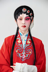 Female actress in red performing Chinese opera movements