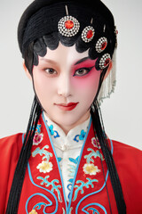 Female actress in red performing Chinese opera movements