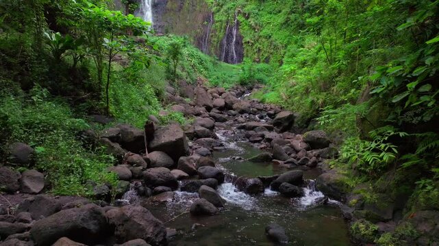 River cascades Faarumai Valley Waterfall Tahiti Island French Polynesia aerial drone Three Falls Trail Les Trios picturesque Vaimahuta Tiarei Hitiaa watershed jungle forest forward pan up motion