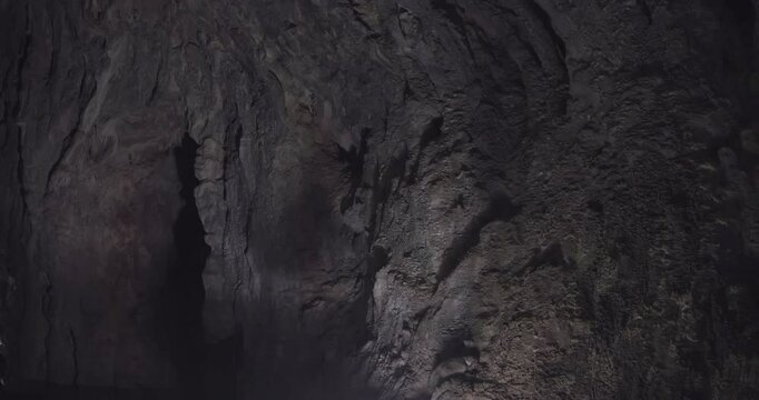 Inside the cave, light beautifully shimmers across the walls, speleology