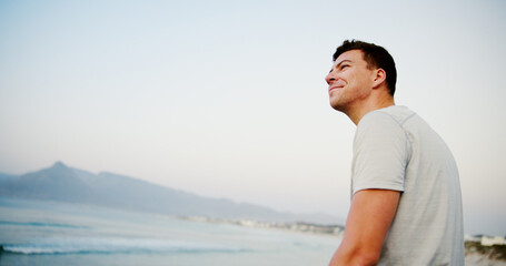 Man, thinking and beach sand for vacation, travel and outdoor for peaceful waves in nature. Male...
