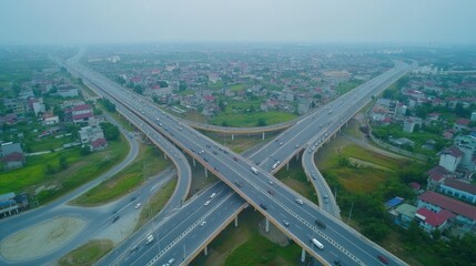 Fototapeta premium Aerial view of a busy highway interchange with multiple lanes of traffic flowing in all directions.