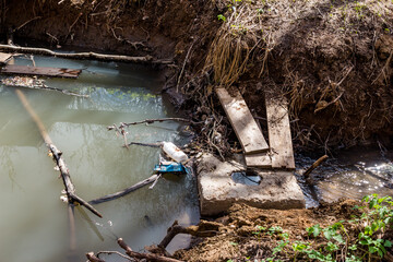 A dam on a small stream formed by a concrete block