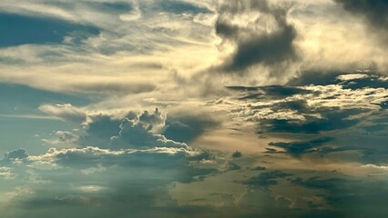 An incredibly beautiful view of clouds in the blue sky, illuminated by the setting sun after the rain