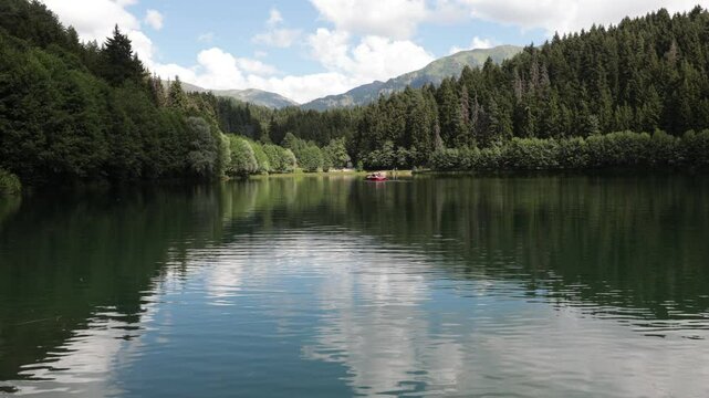 Calm water of a lake in the forest among the mountains. Landscape or nature background 4k video. Karagol Sahara National Park in Savsat district of Artvin in Turkey.