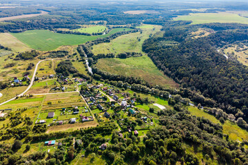 Aerial view of a settlement surrounded by fields and forests. Village Ignatyevskoye Otdelenie, Maloyaroslavetsky District, Kaluga Region, Russia