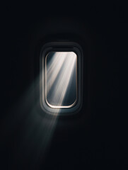 Airplane window with sun rays shining through, creating a serene atmosphere.