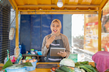 In a lively market, a friendly vendor enthusiastically offers fresh, quality produce