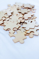 Fototapeta premium Business strategy puzzle pieces on white cloth indoor workspace photo composition soft lighting conceptual thinking