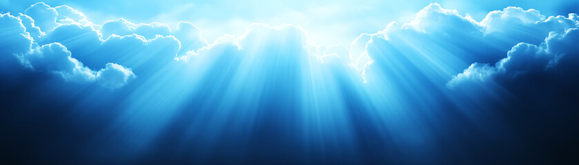 Blue sky and clouds with rays of sunlight streaming through, creating serene atmosphere background.