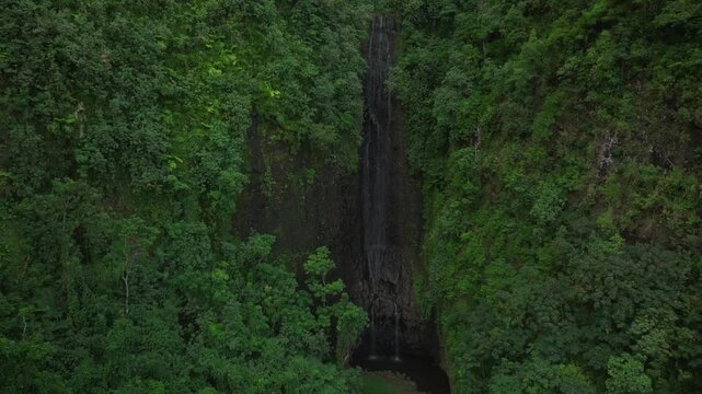 Vairao Taiarapu Vaimahutu Faarumai Matiti Teahupoo Waterfall Falls Tahiti Island aerial drone French Polynesia dense lush green jungle forest Les Trios Cascades pool nature backwards up motion