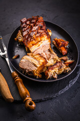 Crispy baked pork belly on black background