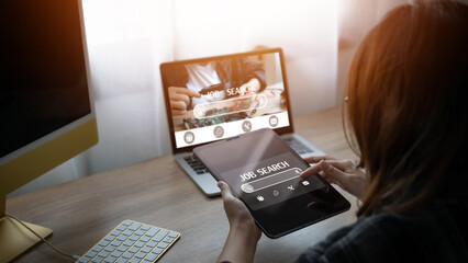 Close-up of a businessman looking at a job search website on a tablet job search concept Find your...