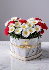 Heart-shaped box filled with fresh daisies and carnations, arranged thoughtfully for International Women&rsquo;s Day, resting on a smooth marble surface