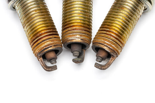 close up view of used spark plug. showing it's tip and electrode wear.