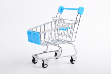 Mini model of blue shopping cart isolated on white background. Shopping cart is empty