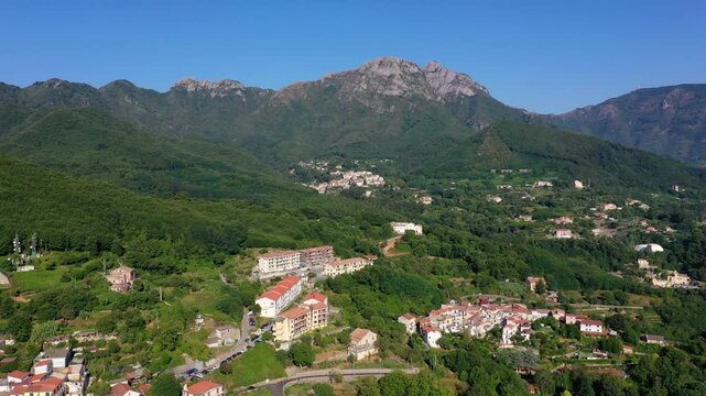 Aerial view from high altitude of rocky mountains and houses on hills near Vietri Sul Mare on a sunny summer day, Raite, Salerno, Italy