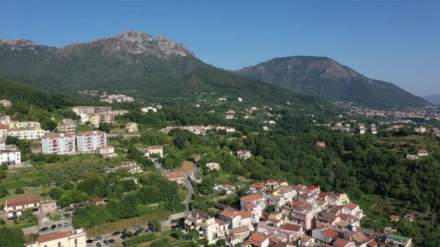 Aerial view from high altitude of rocky mountains and houses on hills near Vietri Sul Mare on a sunny summer day, Raite, Salerno, Italy