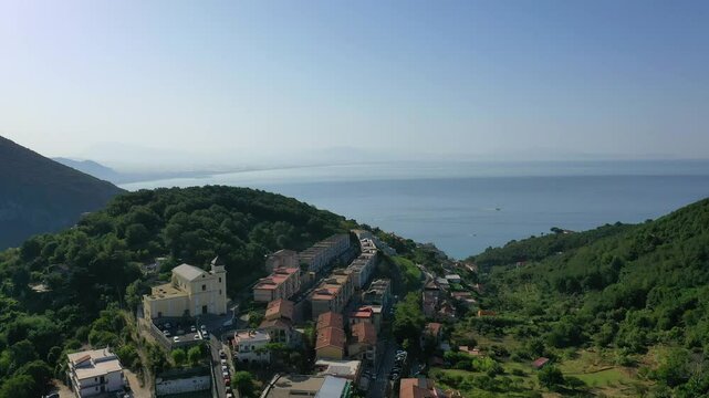 Aerial view from high altitude of rocky mountains and houses on hills near Vietri Sul Mare on a sunny summer day, Raite, Salerno, Italy