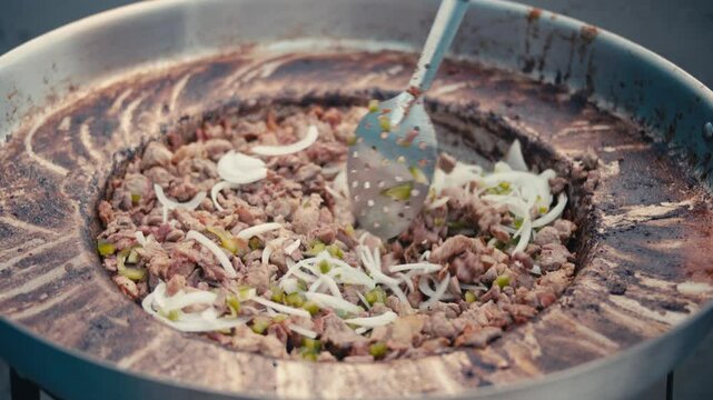 Discada regia, a Mexican food dish, being cooked in slow motion