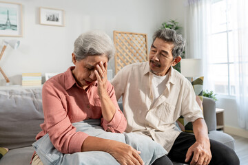Obraz premium Asian elderly husband comforting upset wife crying with tears for problem. 