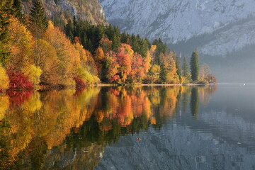 Fototapeta premium Colorful Autumn scenery and reflections on the lake Altausseer See in Altaussee, Bad Aussee, Salzkammergut, Styria, Austria, Europe