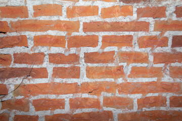 Naklejka premium Close-Up Photography of Rough Red Brick Wall Texture with Porosity
