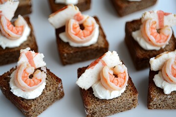 Close-up of a plate of gourmet shrimp canap?s on a white plate.