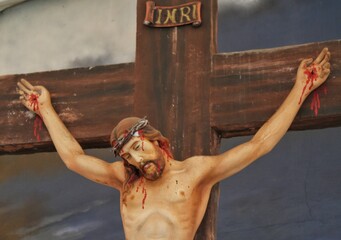 A replica statue of Jesus Christ being crucified placed in a Christian prayer area with Golgotha...