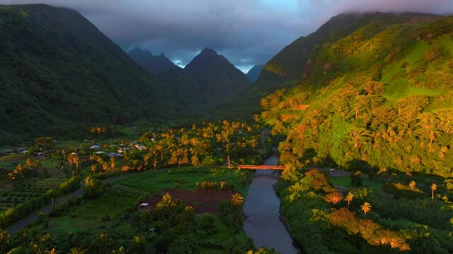 Vallee de Tautira Bay River village Tahiti island French Polynesia aerial drone golden morning sunrise towering jagged mountain peaks valley Teahupoo Mont Rauiri Aorai Taiarapu Taravao backwards