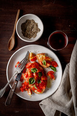 Bruschetta of tomatoes and basil leaves, on the wooden table.