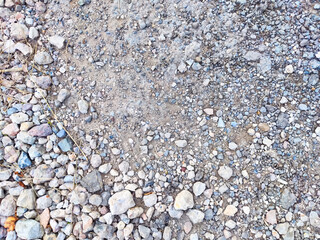 A close-up view of a gravel surface showcases a variety of stones and textures ideal for enhancing...