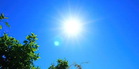 Fototapeta premium A bright blue summer sky with a radiant sun at its center, clear blue sky, clear sky
