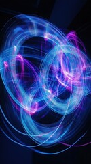 Naklejka premium Swirling light trails in blue and pink create mesmerizing abstract patterns against a black backdrop, showcasing a dynamic display of color and movement during a nighttime event.