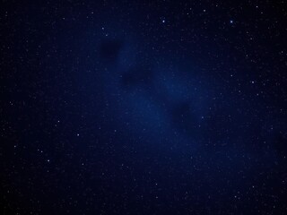 Fototapeta premium A vast expanse of twinkling stars and galaxies in a dark blue background, astronomy, intergalactic space, galaxy cluster