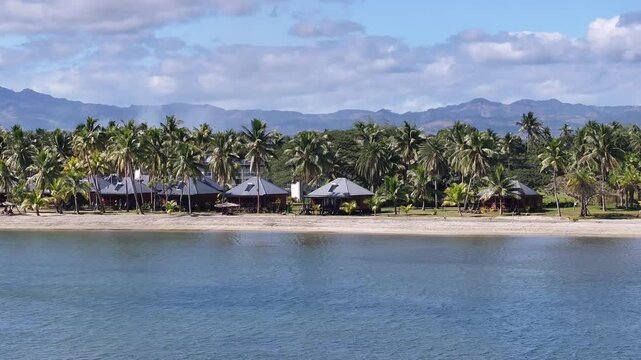 Beachfront Cottages At Wailoaloa Beach In Fiji Island. - aerial shot