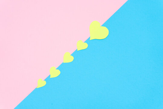 group of yellow hearts on a pink and blue background, valentine background . Valentine concept